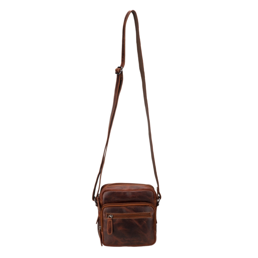 Minori Leather Cove Leather Crossbody Bag in Chestnut with adjustable strap and sleek design, showcasing high-quality leather craftsmanship.