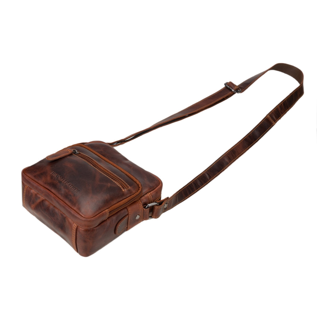 Minori Leather Cove crossbody bag in chestnut leather with adjustable strap and sleek design.