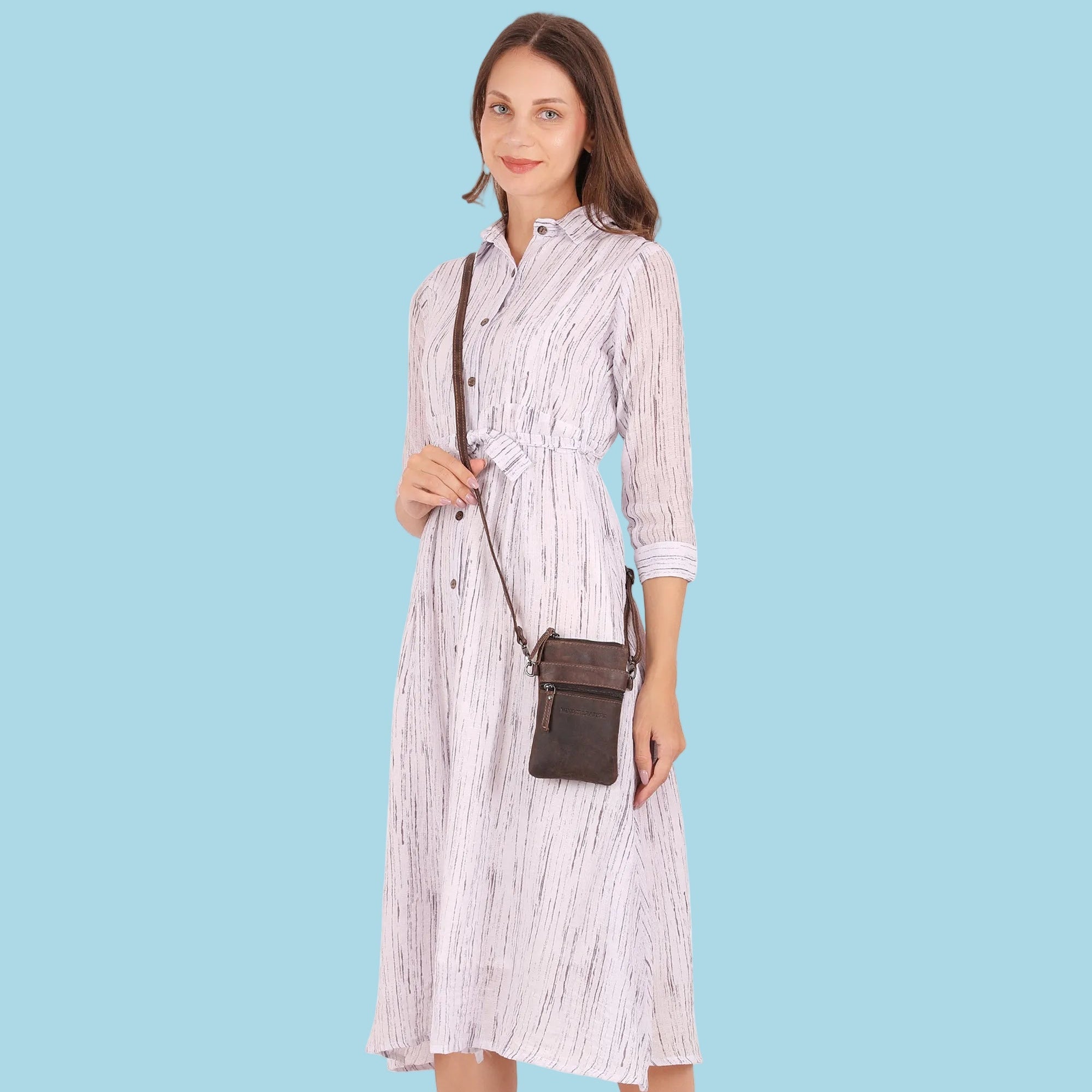 Minori Leather Ashford brown leather sling bag for unisex wear, featuring adjustable strap and compact design.