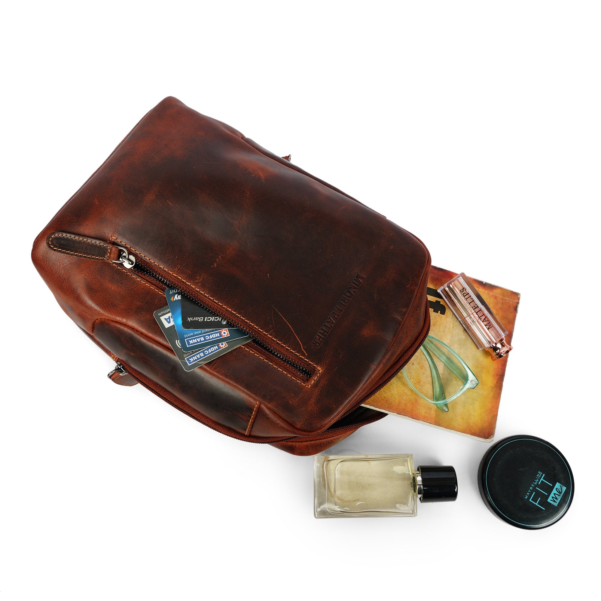 Minori Leather Luxe Leather Sling Chestnut crossbody bag with adjustable strap and sleek design, shown on a neutral background.
