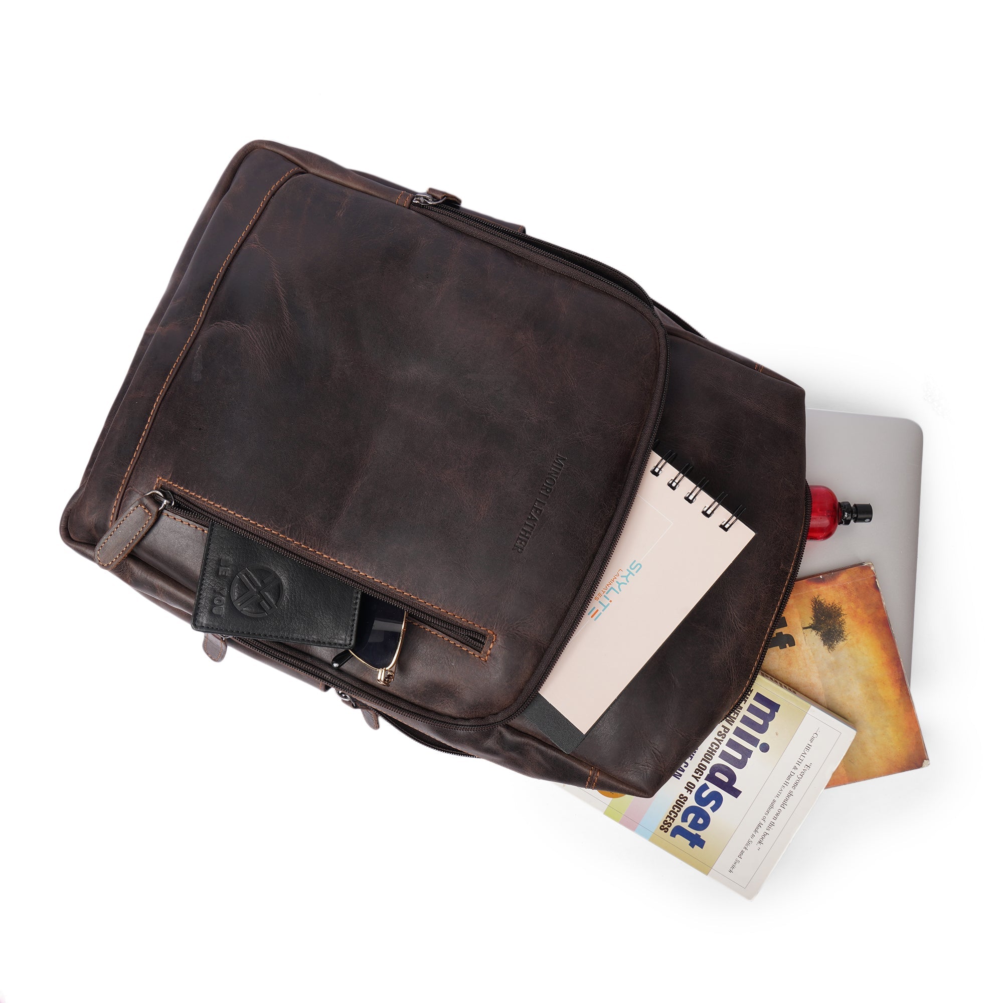 Minori Leather Oslo leather laptop backpack with 15.6-inch compartment, featuring sleek design and durable leather material.