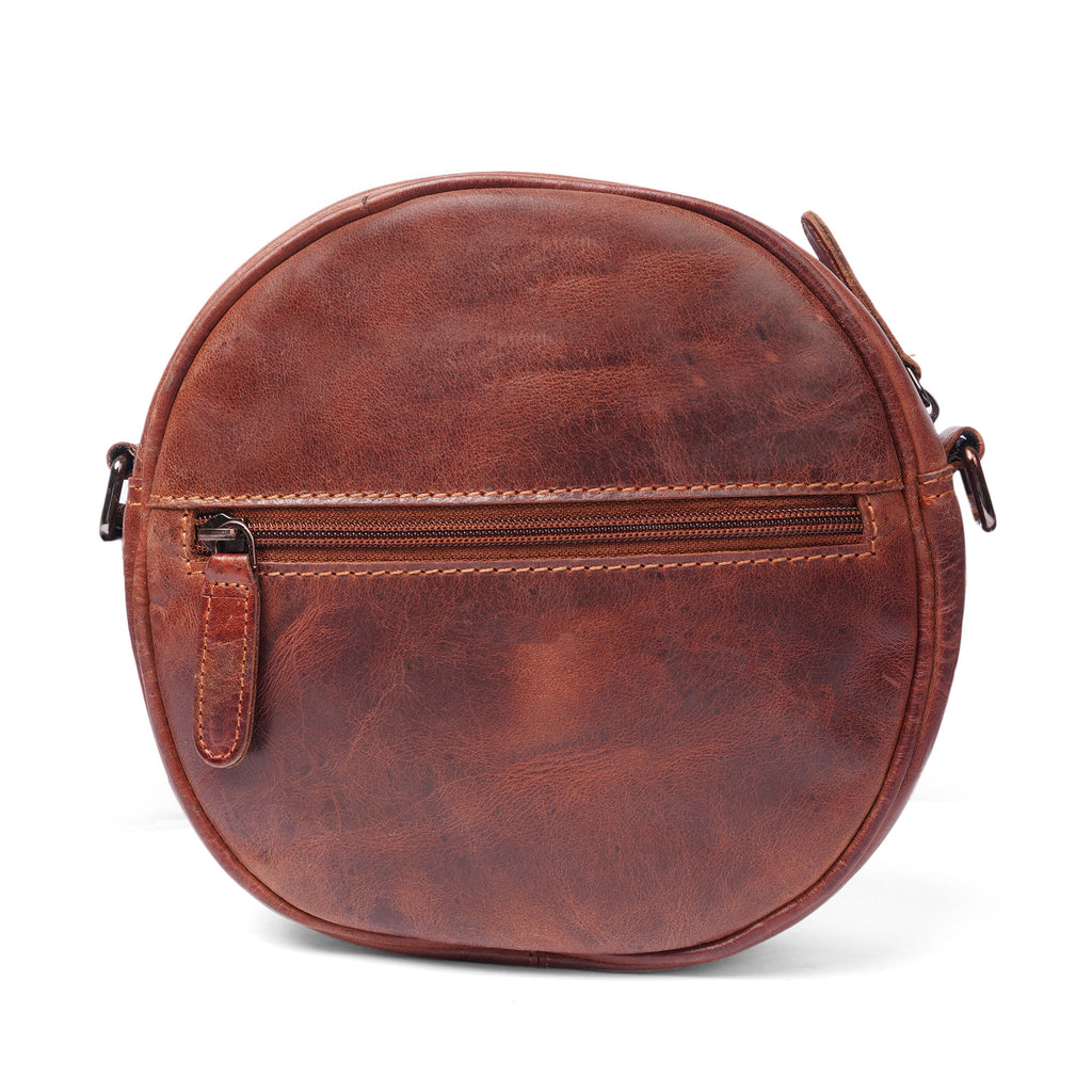 Luna leather round crossbody bag by Minori Leather in chestnut, brown, and hair-on brown leather with adjustable strap.