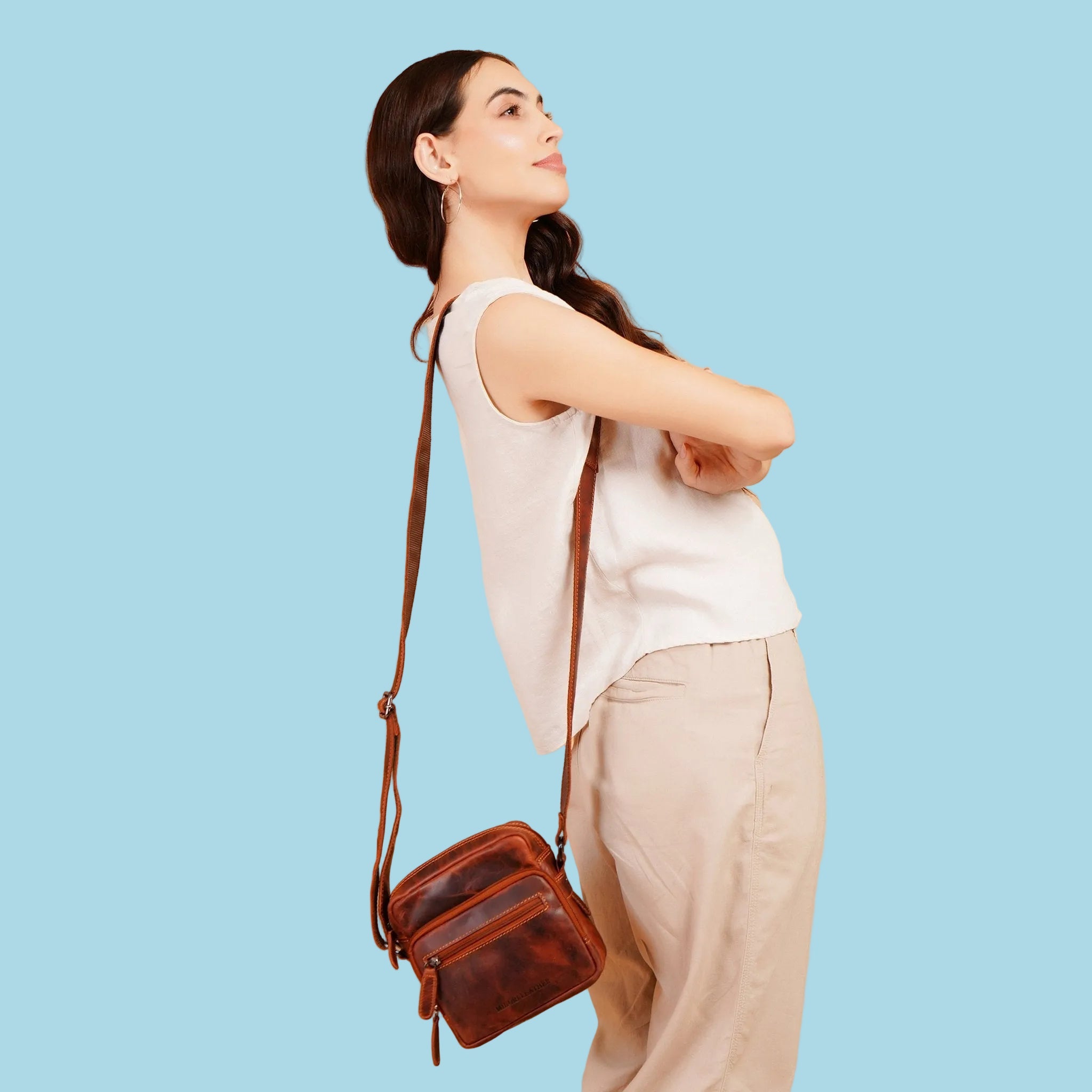 Minori Leather Cove leather crossbody bag in chestnut with adjustable strap and sleek design.