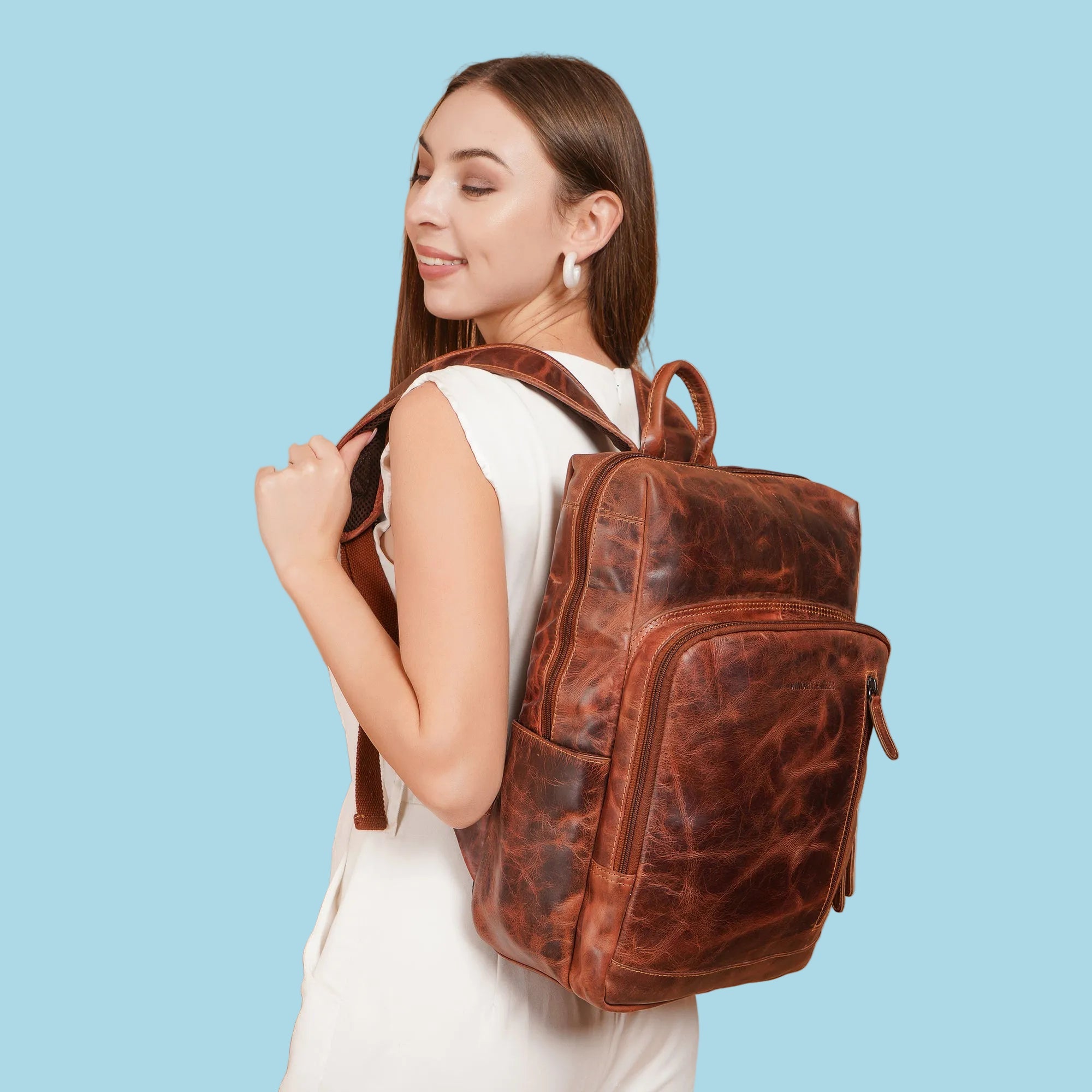 Minori Leather Oslo leather backpack for 15.6-inch laptops, featuring a sleek design with multiple compartments and adjustable straps.