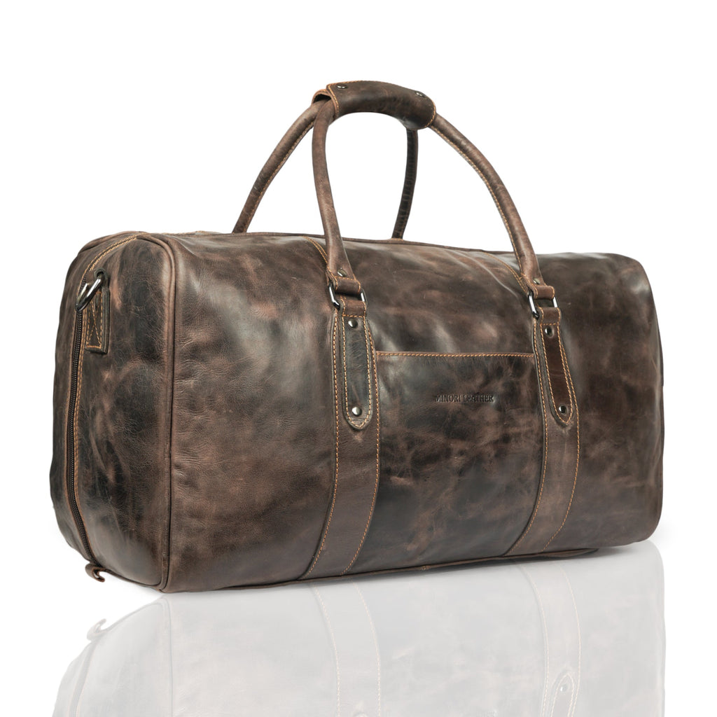 Minori Leather Riley brown leather duffle bag, stylish and spacious with top handles and a zip closure, ideal for travel or weekend trips.